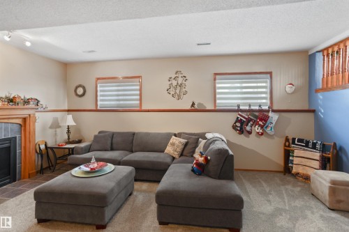 26 Elbow Drive, Devon, AB - Indoor Photo Showing Living Room With Fireplace