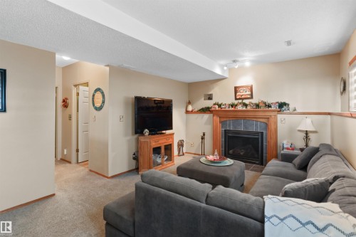 26 Elbow Drive, Devon, AB - Indoor Photo Showing Living Room With Fireplace