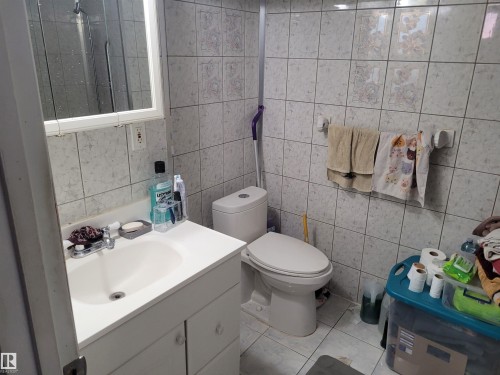 Bathroom with tile walls, vanity, and light tile patterned flooring - 11616 152 Avenue, Edmonton, AB - Indoor Photo Showing Bathroom