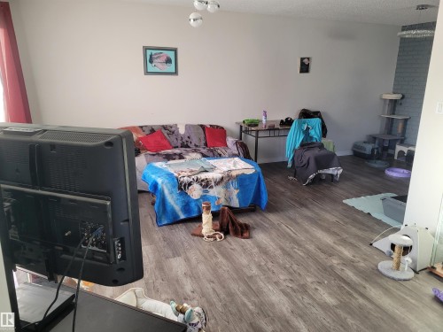 Bedroom featuring wood finished floors and a textured ceiling - 11616 152 Avenue, Edmonton, AB - Indoor Photo Showing Other Room