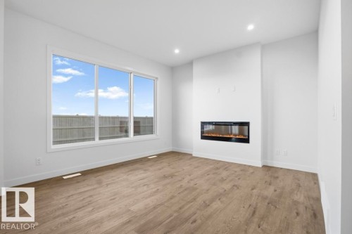 303 Paterson Link, Edmonton, AB - Indoor Photo Showing Living Room With Fireplace
