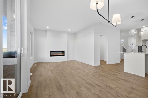 303 Paterson Link, Edmonton, AB - Indoor Photo Showing Kitchen With Fireplace