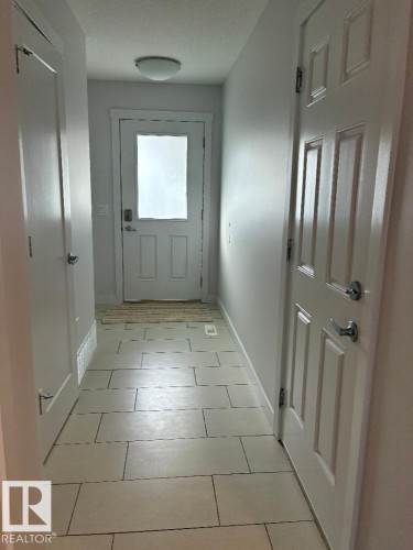 Entryway featuring tile patterned floors and baseboards - 2433 Glenridding Boulevard, Edmonton, AB - Indoor Photo Showing Other Room