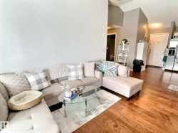 Living area with wood finished floors and high vaulted ceiling - 