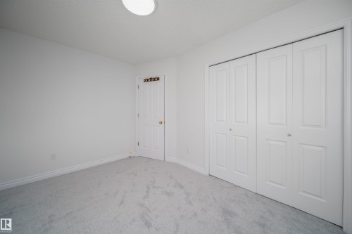 Unfurnished bedroom featuring carpet flooring and a closet - 3504 20 Street, Edmonton, AB - Indoor Photo Showing Other Room