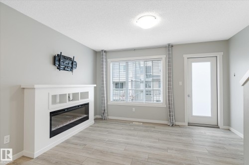 14 1110 Daniels Link Link, Edmonton, AB - Indoor Photo Showing Living Room With Fireplace