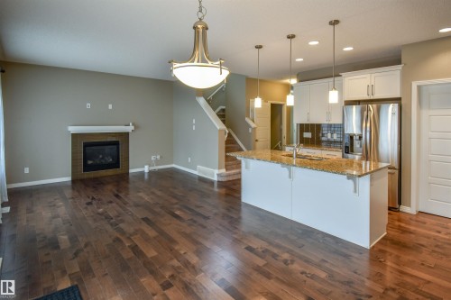 19 Meadowgrove Lane, Spruce Grove, AB - Indoor Photo Showing Kitchen With Fireplace With Upgraded Kitchen
