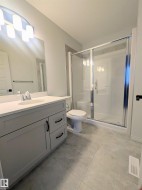 Full bathroom featuring vanity and a stall shower - 