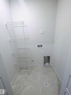 Laundry room featuring hookup for a washing machine and baseboards - 