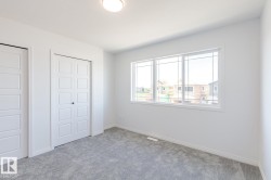 Unfurnished bedroom featuring carpet and multiple closets - 