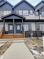 Property entrance with a porch, stone siding, and board and batten siding - 