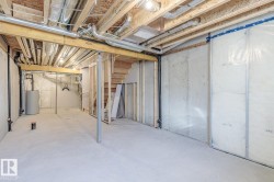 Unfinished basement featuring water heater - 