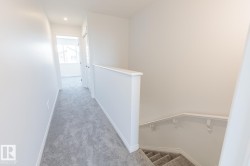 Hall featuring an upstairs landing, carpet floors, and recessed lighting - 
