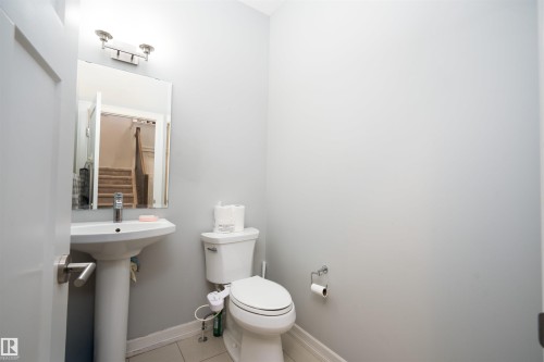 Bathroom with toilet and tile patterned floors - 2060 Ware Road, Edmonton, AB - Indoor Photo Showing Bathroom