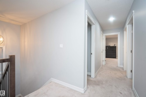 Corridor with light colored carpet and an upstairs landing - 2060 Ware Road, Edmonton, AB - Indoor Photo Showing Other Room