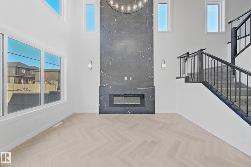 1558 Siskin Link Link, Edmonton, AB - Indoor Photo Showing Other Room With Fireplace