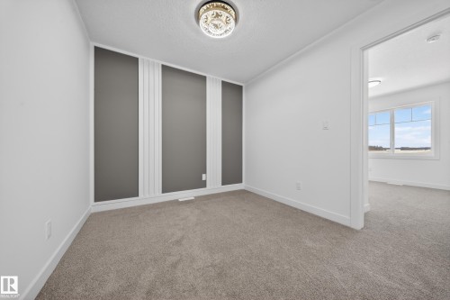 Unfurnished room with a textured ceiling and light colored carpet - 129 Pierwyck Loop, Spruce Grove, AB - Indoor Photo Showing Other Room