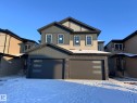 View of front of property with board and batten siding and a garage - 129 Pierwyck Loop, Spruce Grove, AB  - Outdoor With Facade 