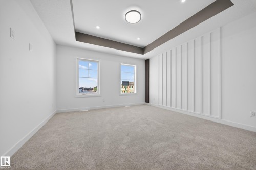 Carpeted spare room featuring a tray ceiling and recessed lighting - 129 Pierwyck Loop, Spruce Grove, AB - Indoor Photo Showing Other Room