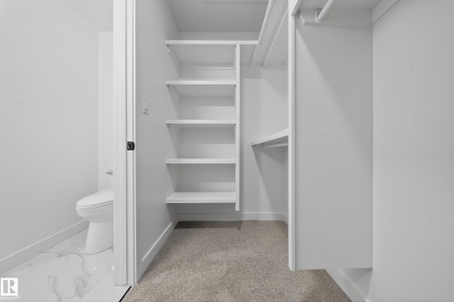 Walk in closet featuring light marble finish floors and light carpet - 129 Pierwyck Loop, Spruce Grove, AB - Indoor With Storage