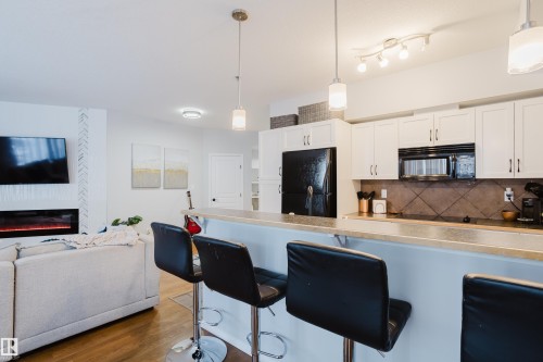 140 4827 104A Street, Edmonton, AB - Indoor Photo Showing Kitchen With Fireplace