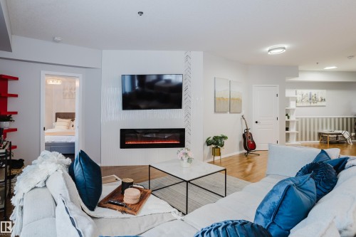 140 4827 104A Street, Edmonton, AB - Indoor Photo Showing Living Room With Fireplace