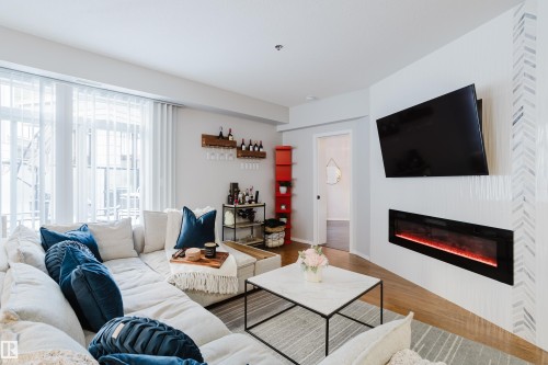 140 4827 104A Street, Edmonton, AB - Indoor Photo Showing Living Room With Fireplace