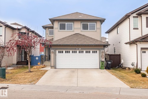 Traditional-style house with a shingled roof, concrete driveway, and a garage - 1888 33 Street, Edmonton, AB - Outdoor With Facade