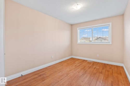 Spare room with a textured ceiling and light wood-style flooring - 1888 33 Street, Edmonton, AB - Indoor Photo Showing Other Room