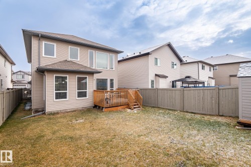 Rear view of property featuring a wooden deck, a fenced backyard, a residential view, and roof with shingles - 1888 33 Street, Edmonton, AB - Outdoor With Exterior