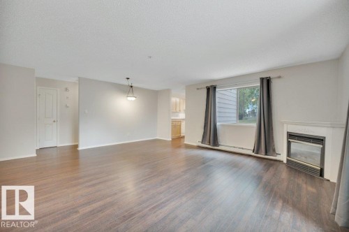 102 2903 Rabbit Hill Road, Edmonton, AB - Indoor Photo Showing Living Room With Fireplace