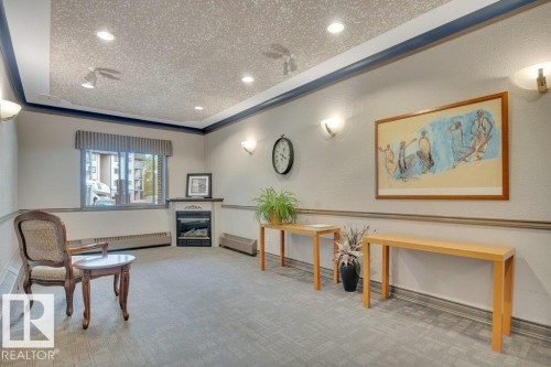 102 2903 Rabbit Hill Road, Edmonton, AB - Indoor Photo Showing Other Room With Fireplace