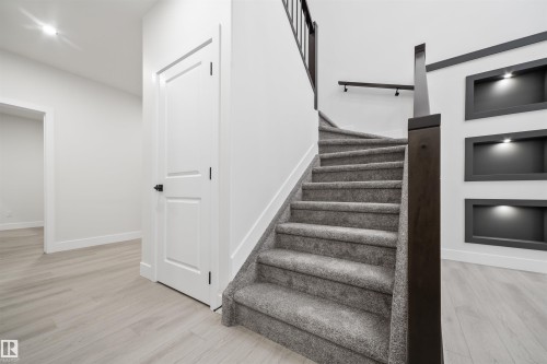 Staircase featuring wood finished floors - 3164 Magpie Way, Edmonton, AB - Indoor Photo Showing Other Room