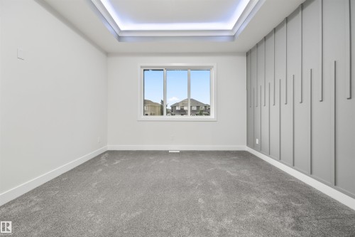 Unfurnished bedroom featuring carpet flooring and a raised ceiling - 3164 Magpie Way, Edmonton, AB - Indoor Photo Showing Other Room