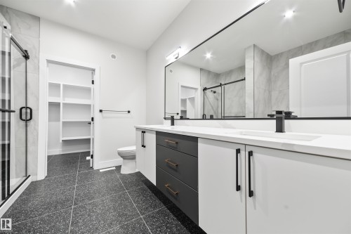 Full bathroom with double vanity, a stall shower, and a spacious closet - 3164 Magpie Way, Edmonton, AB - Indoor Photo Showing Bathroom