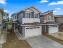 View of front facade featuring board and batten siding, a shingled roof, concrete driveway, and an attached garage - 3164 Magpie Way, Edmonton, AB  - Outdoor 
