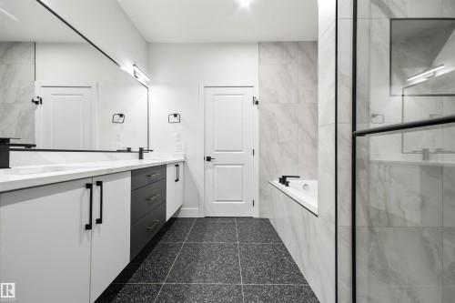 Bathroom with double vanity, a bath, and a marble finish shower - 3164 Magpie Way, Edmonton, AB - Indoor Photo Showing Bathroom