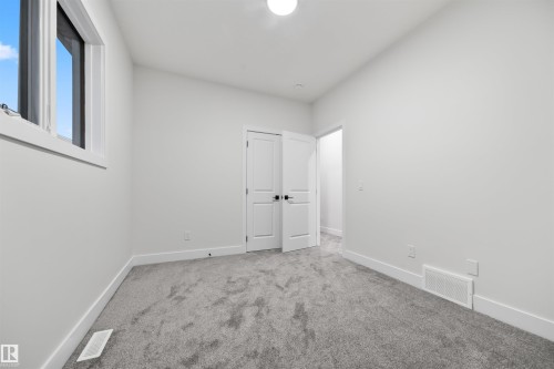 Unfurnished bedroom featuring carpet and baseboards - 3164 Magpie Way, Edmonton, AB - Indoor Photo Showing Other Room