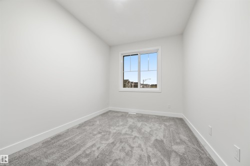 Unfurnished room with baseboards and light carpet - 3164 Magpie Way, Edmonton, AB - Indoor Photo Showing Other Room