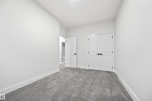 Unfurnished bedroom with carpet and a closet - 3164 Magpie Way, Edmonton, AB - Indoor Photo Showing Other Room