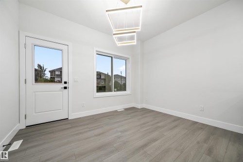 Entrance foyer with light wood-type flooring and baseboards - 3164 Magpie Way, Edmonton, AB - Indoor Photo Showing Other Room