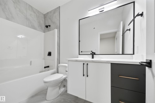 Bathroom with tub / shower combination, vanity, and light marble finish flooring - 3164 Magpie Way, Edmonton, AB - Indoor Photo Showing Bathroom