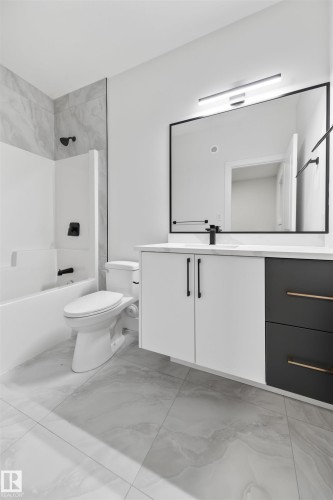 Full bathroom with vanity, light marble finish floors, and washtub / shower combination - 3164 Magpie Way, Edmonton, AB - Indoor Photo Showing Bathroom