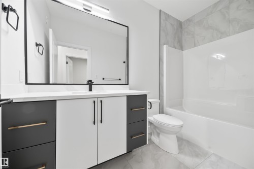 Full bathroom with vanity, light marble finish flooring, and bathing tub / shower combination - 3164 Magpie Way, Edmonton, AB - Indoor Photo Showing Bathroom