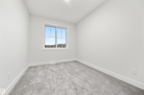 Empty room featuring baseboards and light colored carpet - 3164 Magpie Way, Edmonton, AB - Indoor Photo Showing Other Room