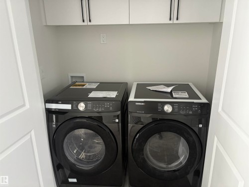 Washroom featuring washer and dryer - 3164 Magpie Way, Edmonton, AB - Indoor Photo Showing Laundry Room