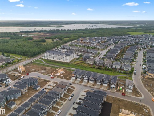 Aerial overview of property's location with a large body of water and nearby suburban area - 3164 Magpie Way, Edmonton, AB - Outdoor With View