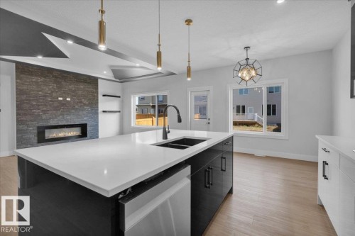 63 Waverly Way, Fort Saskatchewan, AB - Indoor Photo Showing Kitchen With Fireplace With Double Sink With Upgraded Kitchen