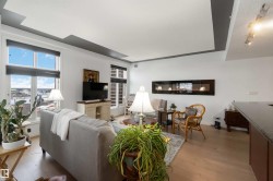 Living area featuring light wood-style flooring and baseboards - 