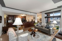 Living area featuring rail lighting and a chandelier - 